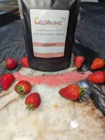 Colorwayz Strawberry Cotton Candy Sugar package displayed on a marble surface, with a line of pink sugar and fresh strawberries adding a natural touch.